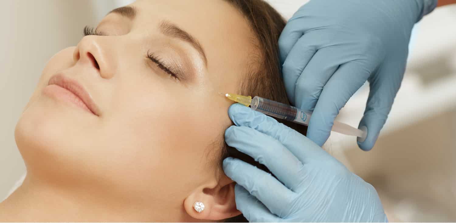 A woman getting a Dysport injection to treat her wrinkles