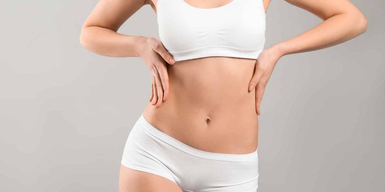 A woman in white underwear after tumescent liposuction