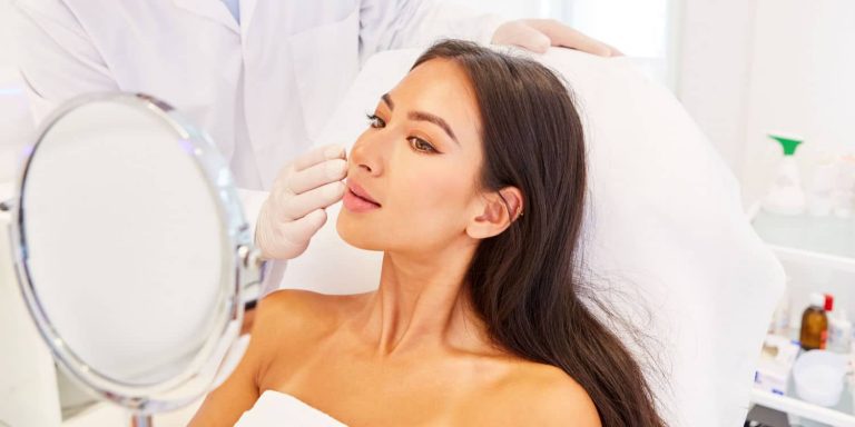 A woman asking plastic surgery questions during a consultation